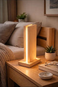 Lumina wooden lamp glowing on a bedside table